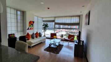 Premium Suite,1 Bedroom, Kitchen | Living area | 32-inch flat-screen TV with cable channels, TV, DVD player
