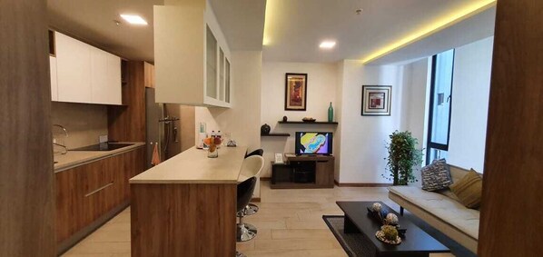 Premium Suite,1 Bedroom, Kitchen | Living area | 32-inch flat-screen TV with cable channels, TV, DVD player