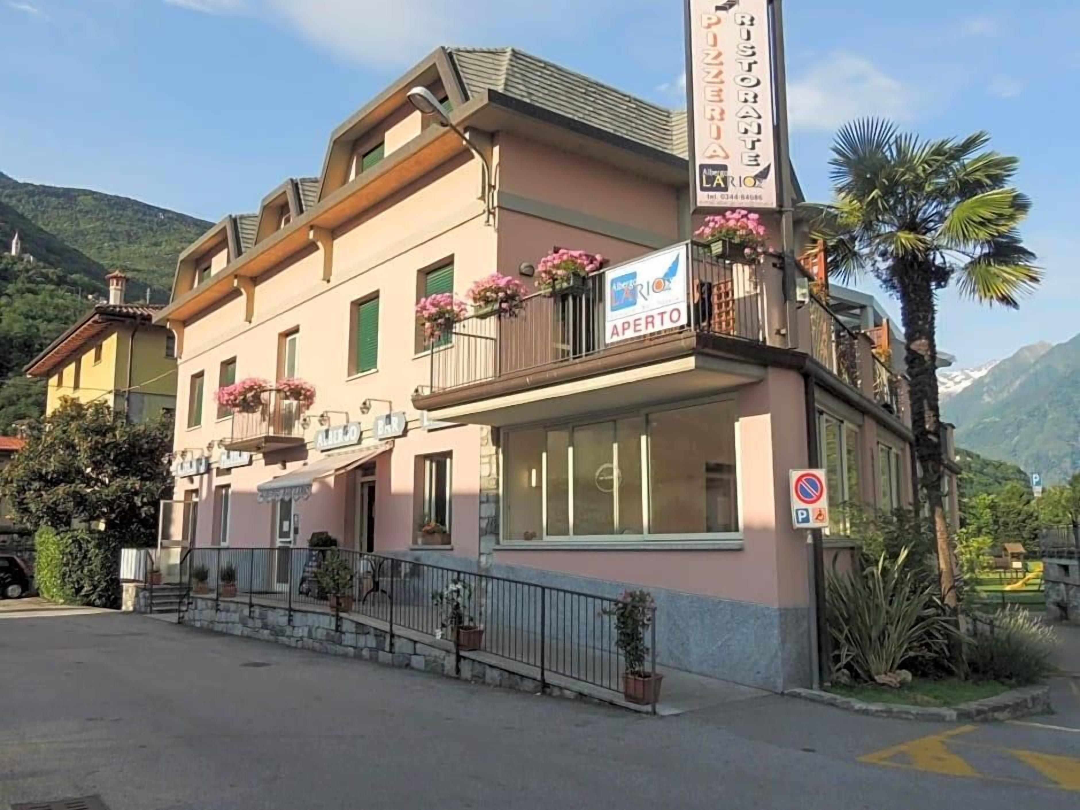 A two-story building with a restaurant sign, a visible entrance, and a mountain backdrop.