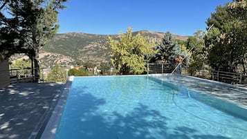 Seasonal outdoor pool, open 10:30 AM to 6:30 PM, pool umbrellas