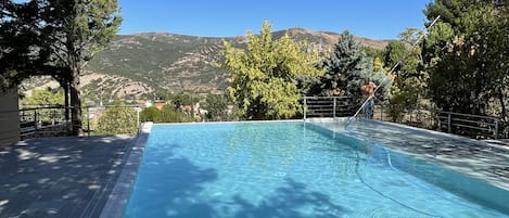 Seasonal outdoor pool, open 10:30 AM to 6:30 PM, pool umbrellas