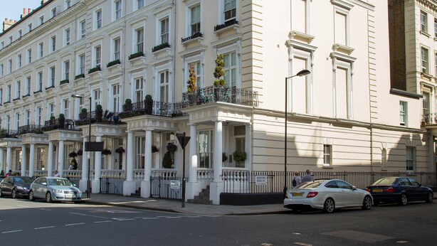 A multi-story building with a symmetrical facade, large windows, and a central entrance with columns. - Princes Square Serviced Apartments by Concept Apartments (London)