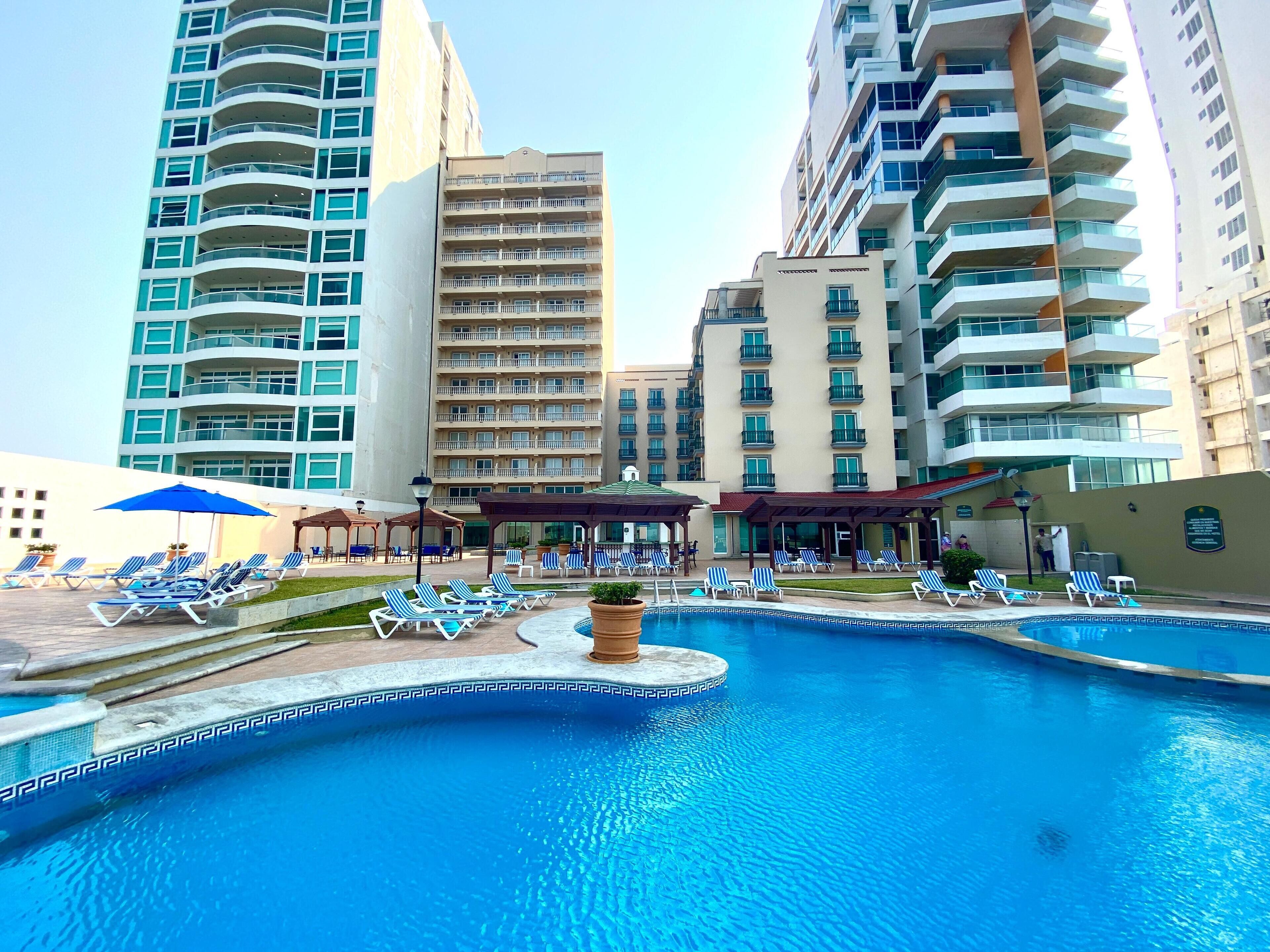 Utomhuspool, parasoller och solstolar