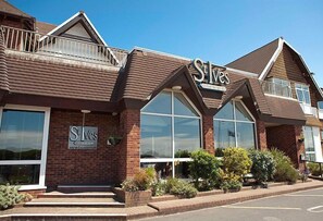 A building with a 'S' logo, large windows, and a brick facade. - St Ives Hotel (Lytham St. Anne's)