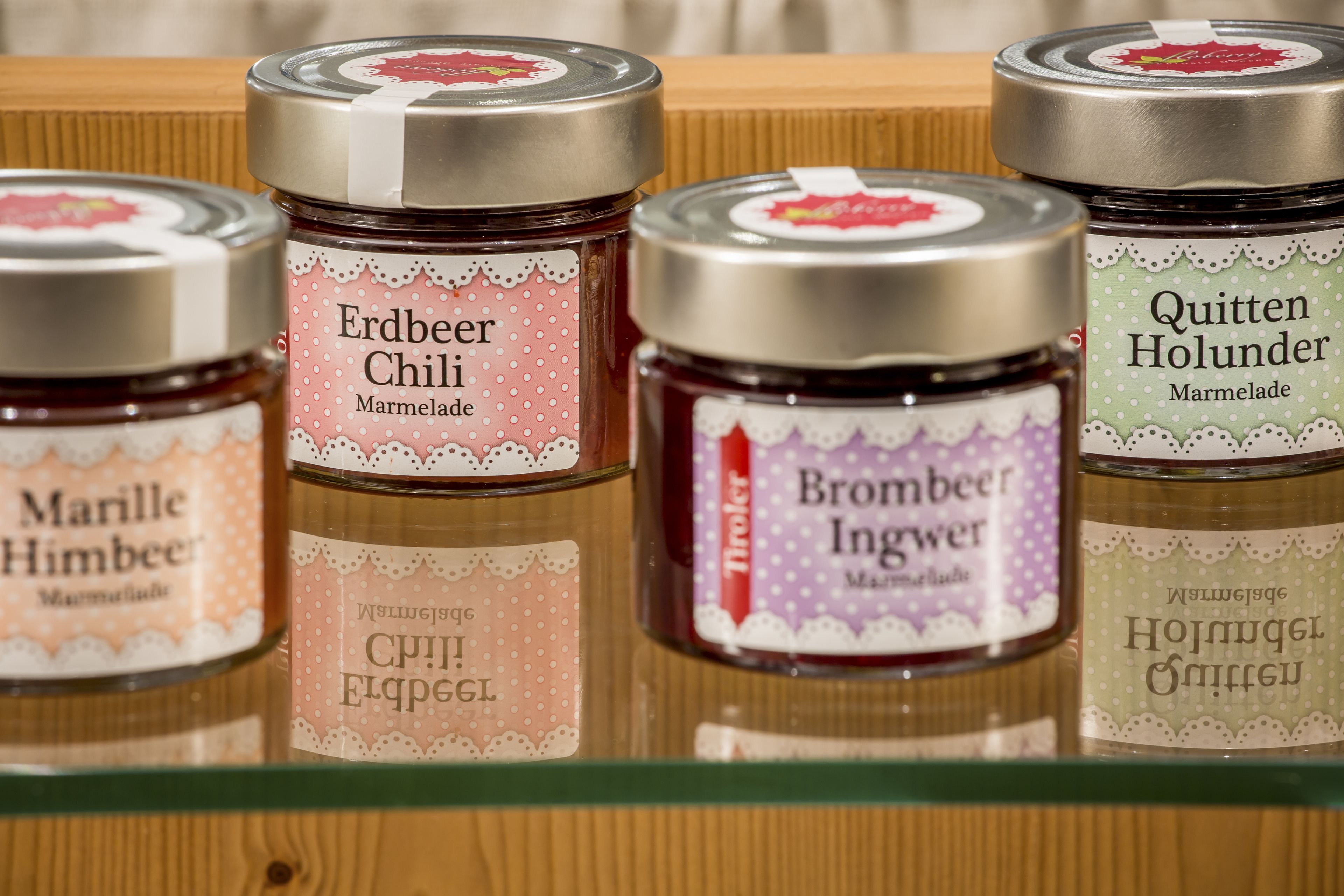 A shelf with jars of marmalade.