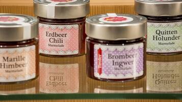 A shelf with jars of marmalade.