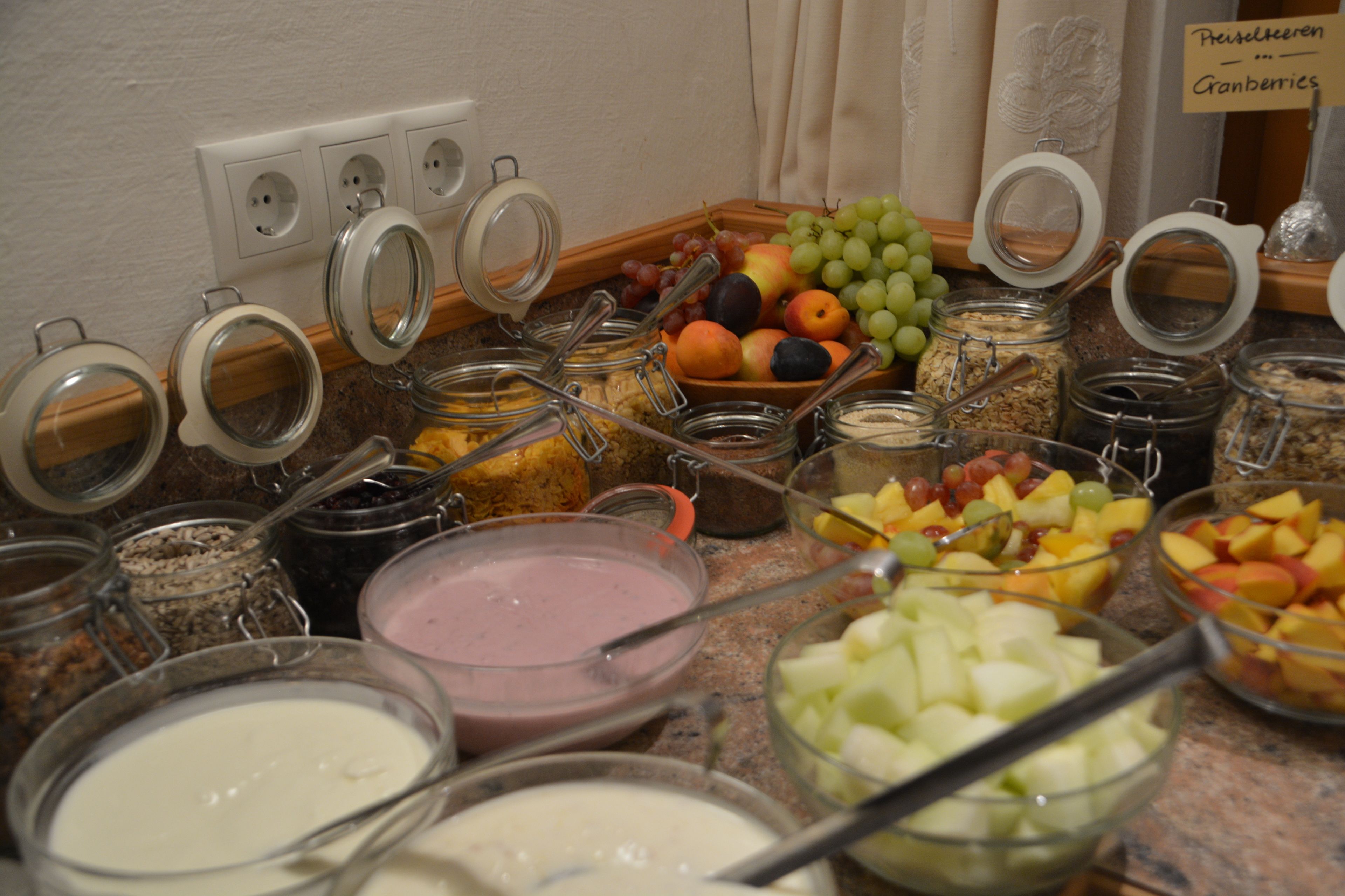 A breakfast buffet with various food items and containers.