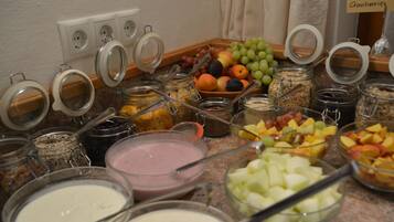 A breakfast buffet with various food items and containers.
