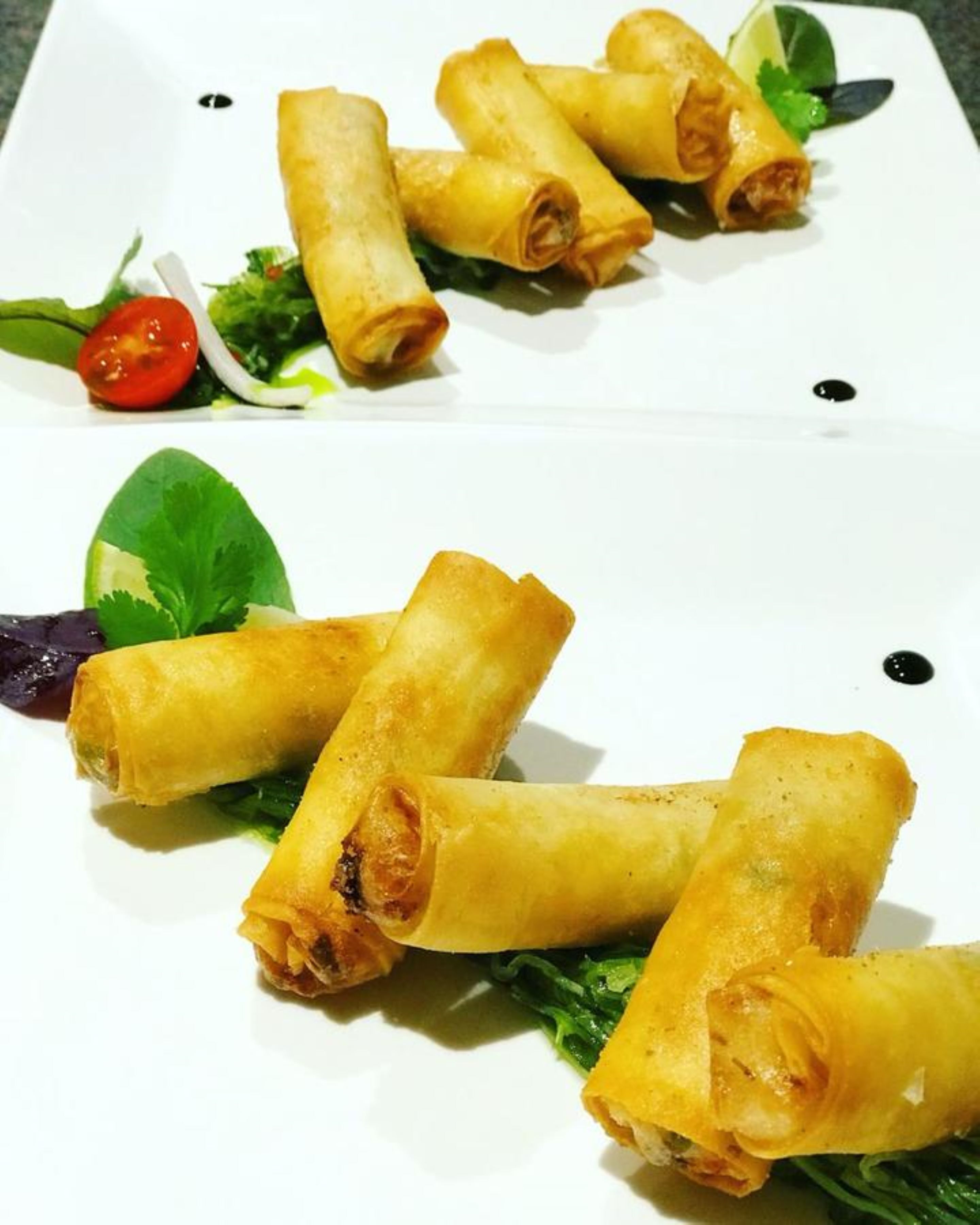 A plate of spring rolls with a side salad.