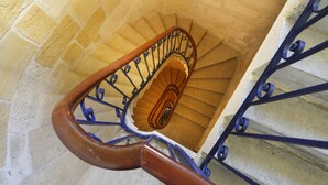 Un escalier en colimaçon avec des marches en bois et des rampes en métal.
