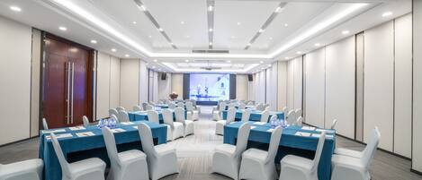 A conference room with tables and chairs arranged for a meeting.