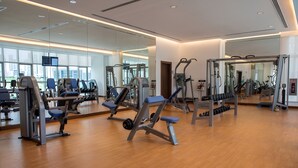 A gym with various exercise equipment, large mirrors, and wooden flooring. - ibis Abu Dhabi Gate (Abu Dhabi)