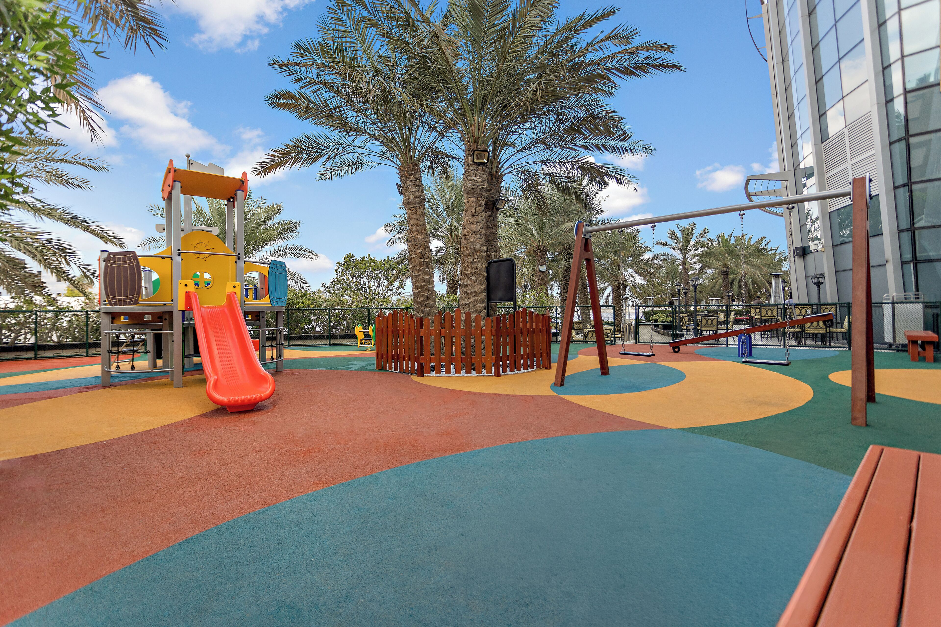 A playground with a slide, swings, and a climbing structure.