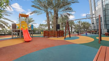 A playground with a slide, swings, and a climbing structure.