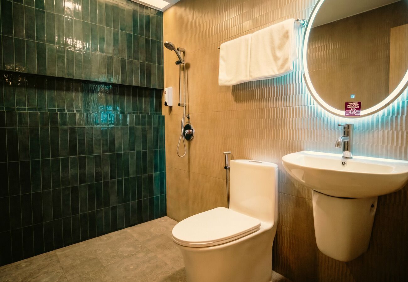 A bathroom with a toilet, a sink, and a shower.