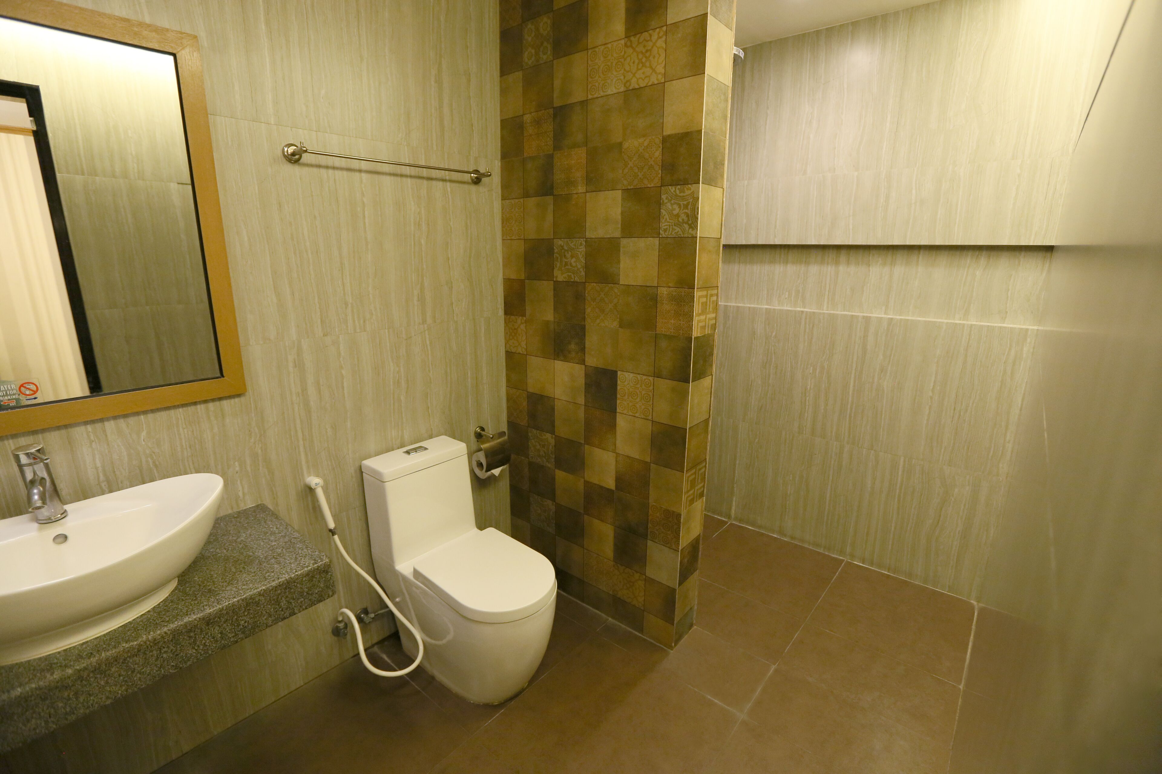 A bathroom with a sink, toilet, and shower area.