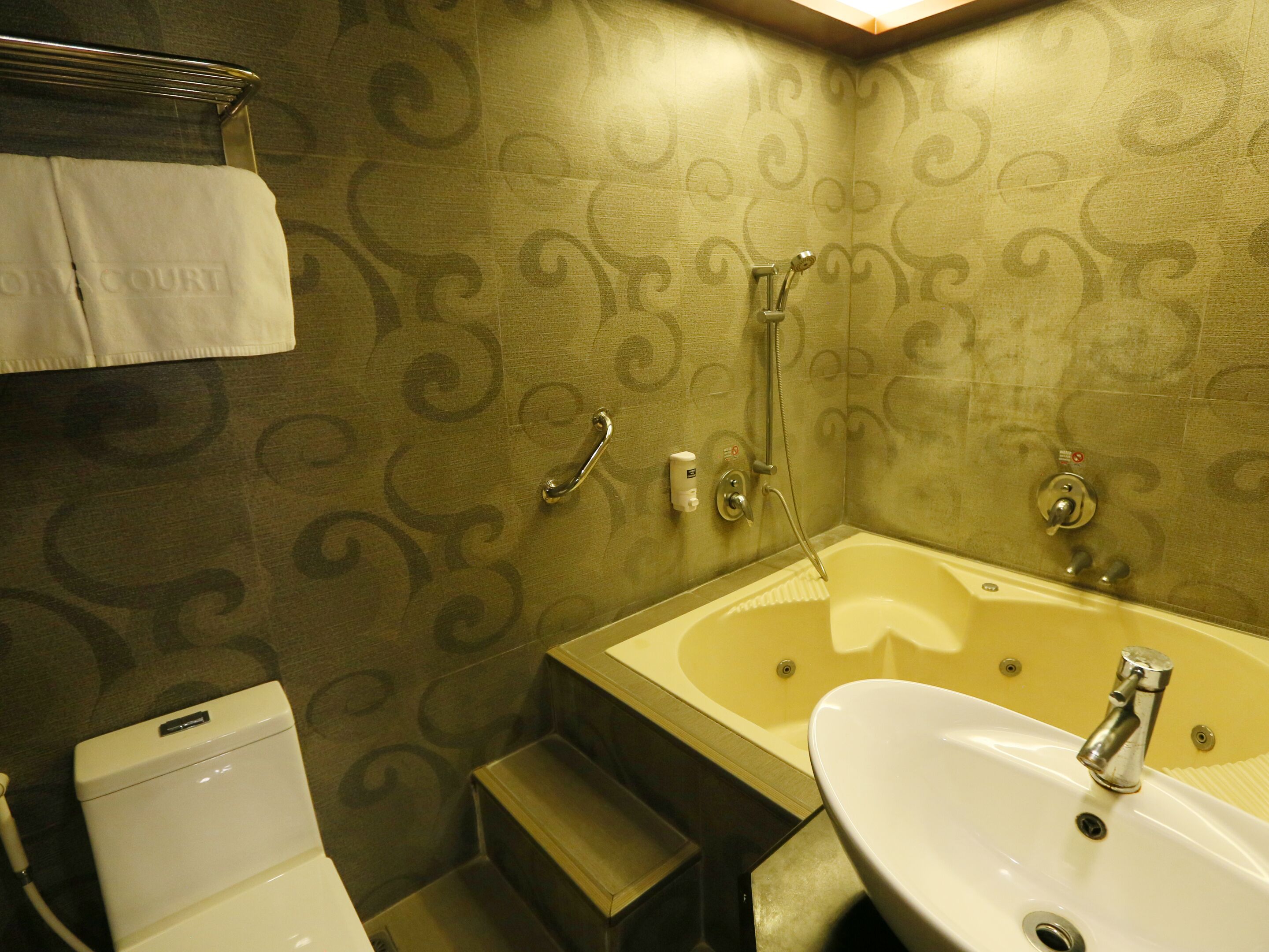 A bathroom with a bathtub, sink, and toilet.