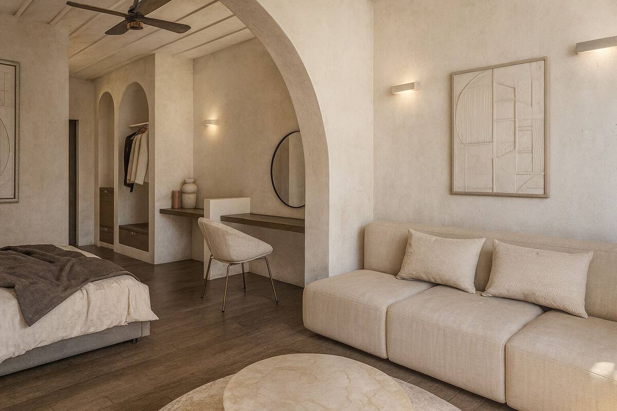 Une chambre moderne avec un lit, un canapé, une chaise et un ventilateur de plafond.