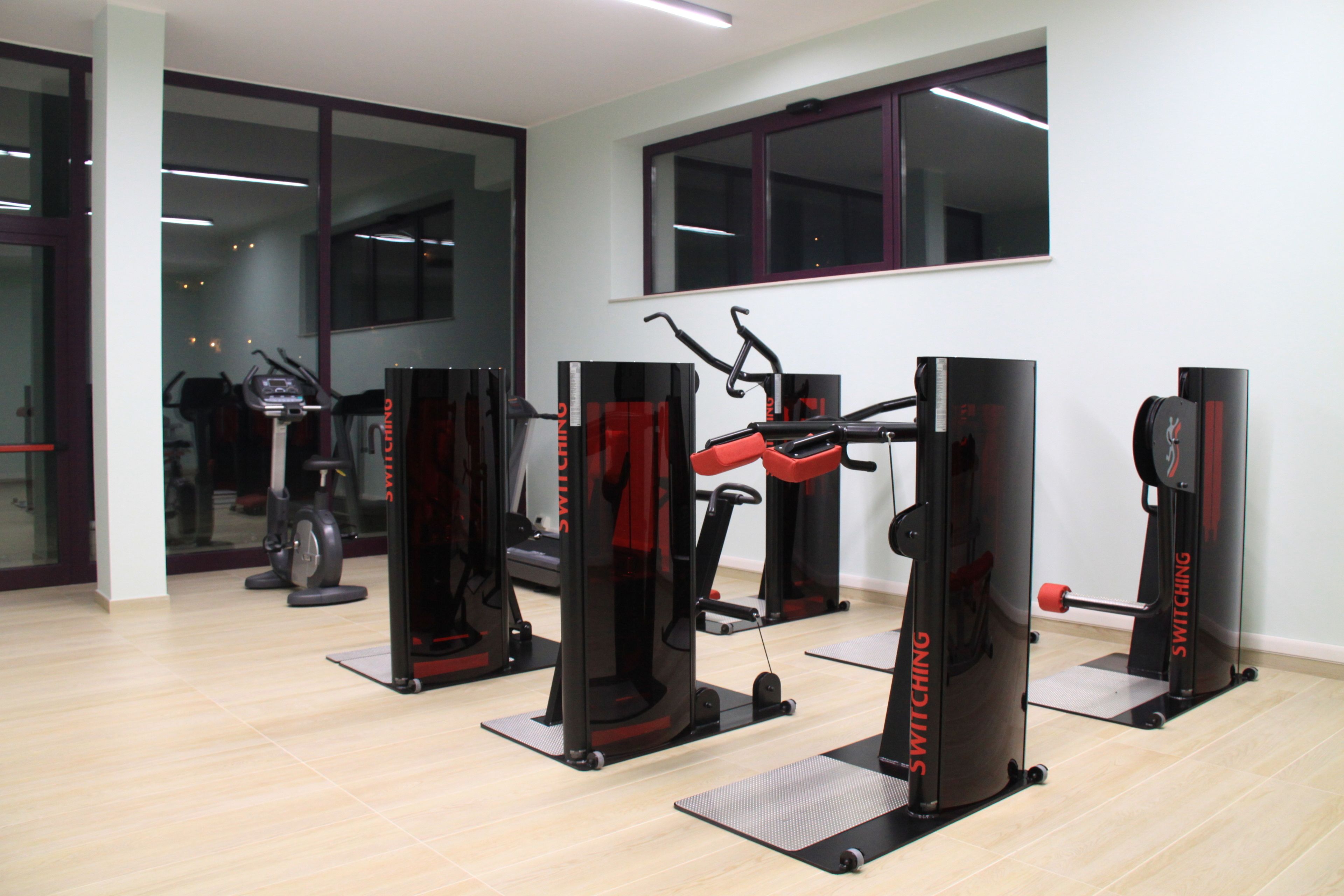 A gym with cardio machines and weightlifting equipment.