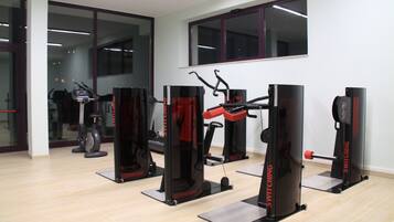 A gym with cardio machines and weightlifting equipment.