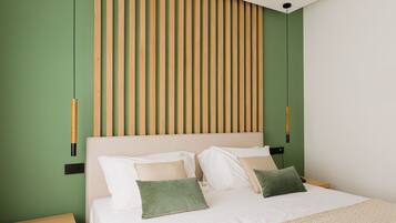 A modern bedroom with a large bed, green walls, wooden slats on the headboard, and a bedside table with a lamp.