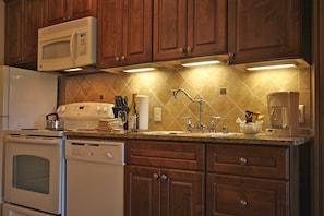 Full-sized fridge, microwave, stovetop, dishwasher