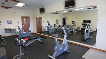 A gym with stationary bikes, treadmills, and exercise equipment.