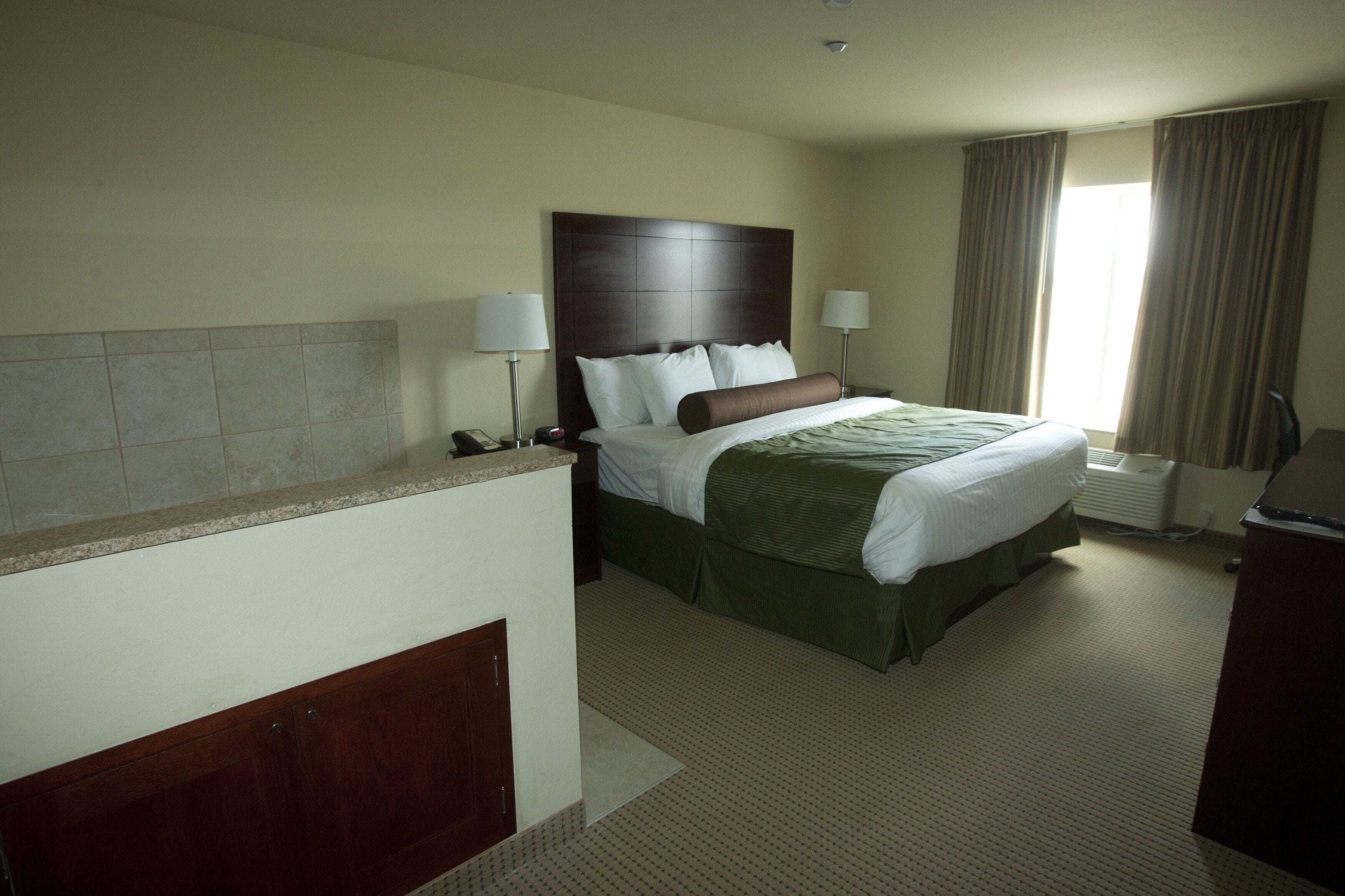 suite, 1 king bed, whirlpool tub, non smoking | in-room safe, desk, laptop workspace, iron/ironing board