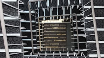 A metal rack with a sign displaying "welcome" in multiple languages.