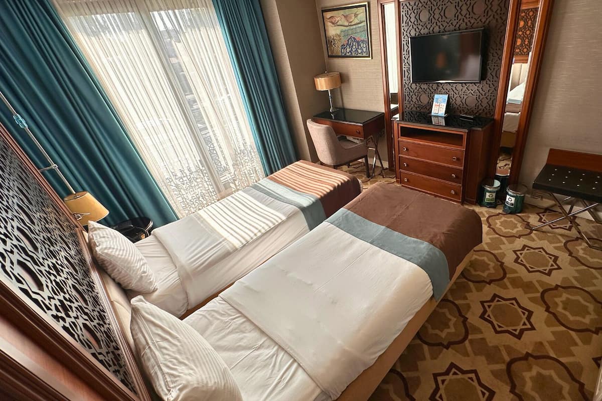 Family Quadruple Room | Minibar, in-room safe, desk, laptop workspace