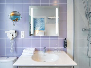 A bathroom with a white sink, mirror, and towel rack. - ibis Styles Calais Centre (Calais)