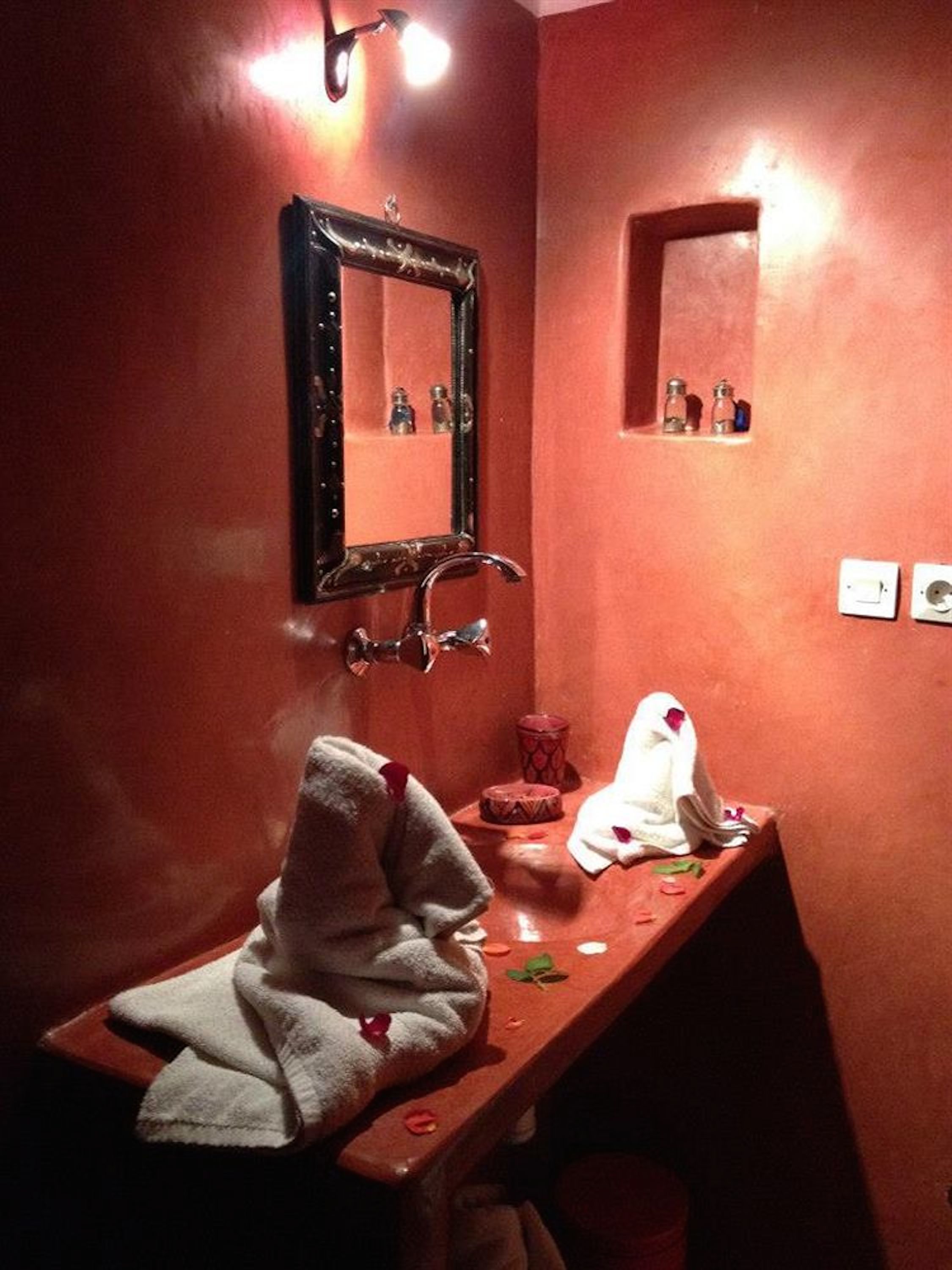 A bathroom with a mirror, sink, and towel rack.