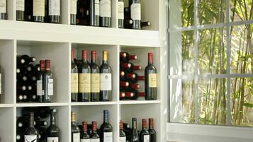 A wine cellar with shelves stocked with various wine bottles.