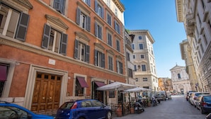 A narrow street lined with parked cars and buildings with classic architecture. - La Residenza dell'Angelo (Rome)