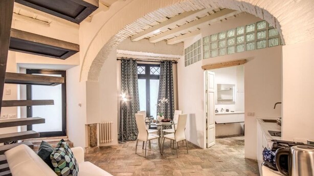 A modern interior with a dining area, kitchen, and living space. - La Residenza dell'Angelo (Rome)