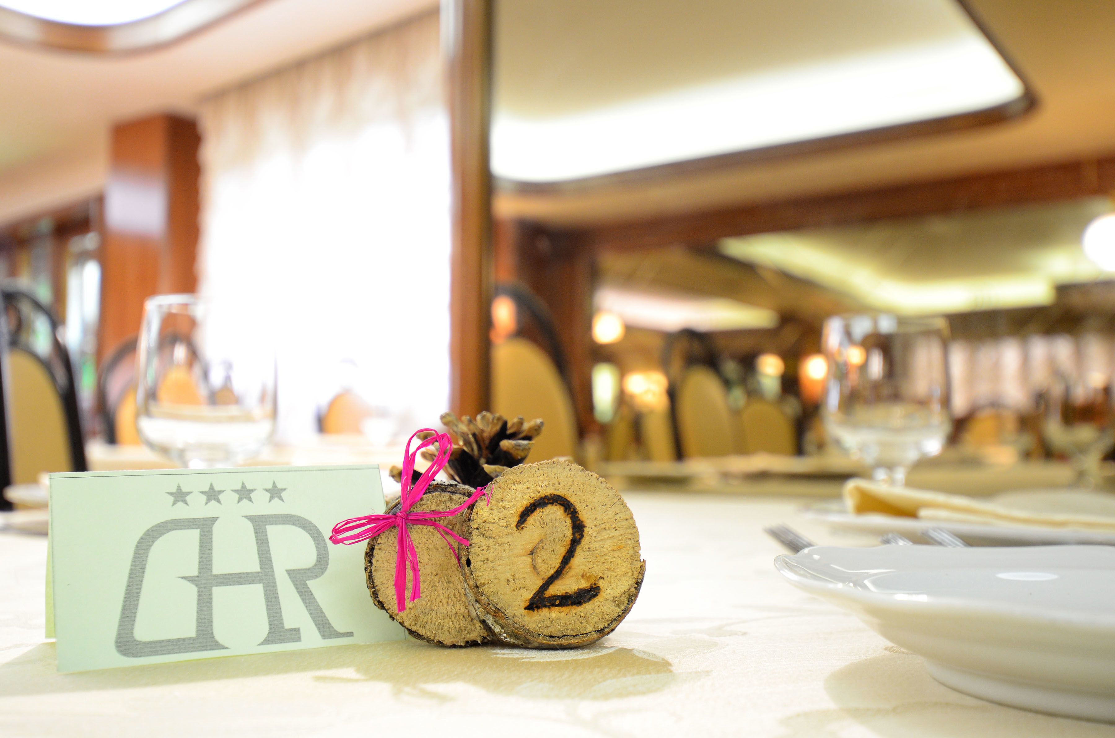 A table setting with a name card, a number card, and a glass of water.