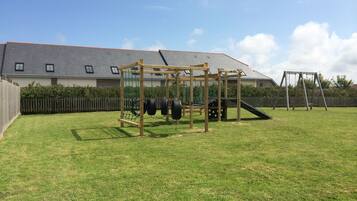 Enjoy a family-friendly yard with a play structure featuring a rope swing and slide.