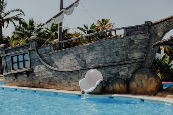 A pirate ship-themed pool with a slide.