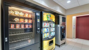 A vending machine with snacks and a drink dispenser.