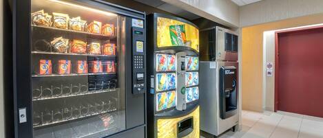 A vending machine with snacks and a drink dispenser.