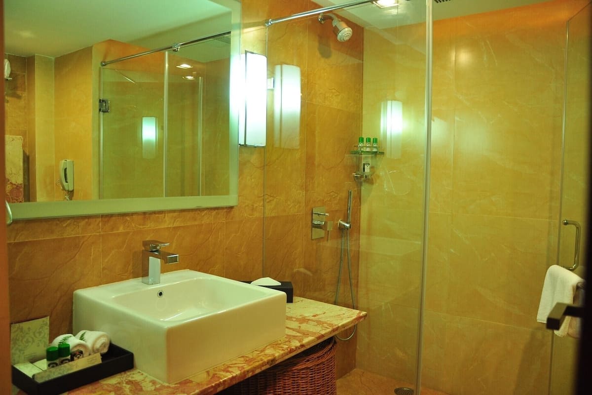 Shower, designer toiletries, slippers, towels