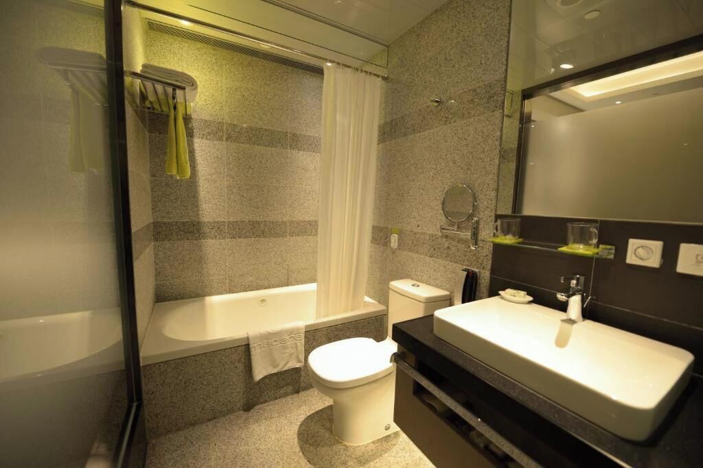 Bathroom | Designer toiletries, hair dryer, slippers, towels