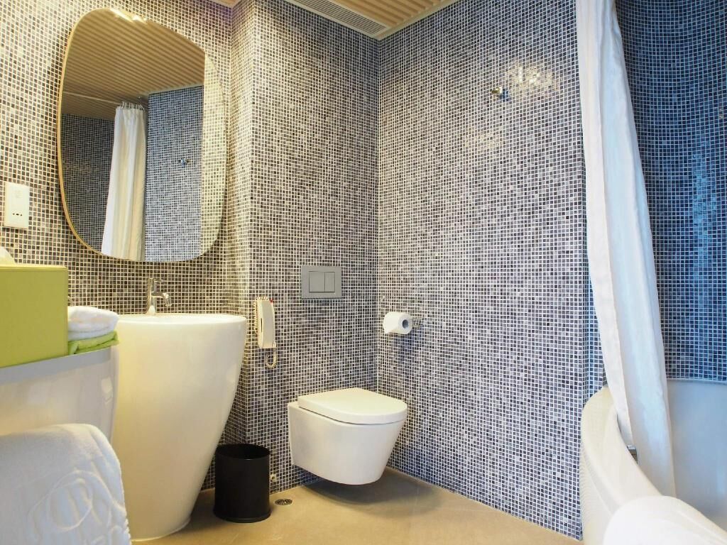 Bathroom | Designer toiletries, hair dryer, slippers, towels