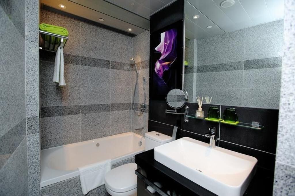 Designer toiletries, hair dryer, slippers, towels