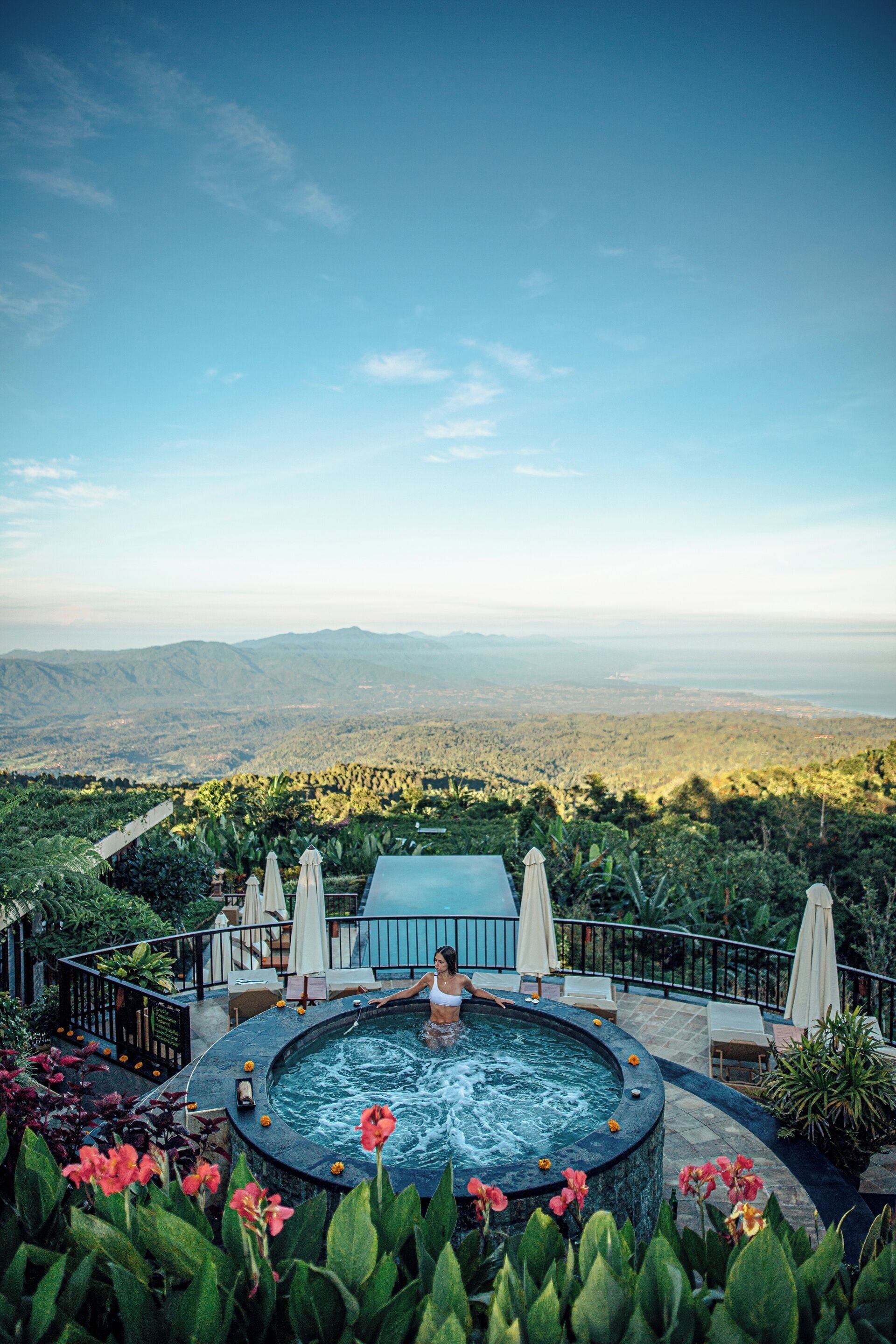 A hot tub with a panoramic view of a mountainous landscape.