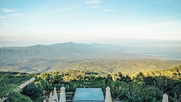 A hot tub with a panoramic view of a mountainous landscape.
