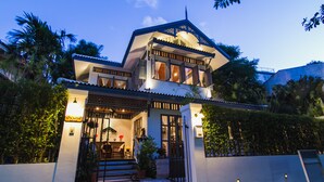 A two-story house with a balcony, a front door, and a staircase leading to the entrance. - Baan Noppawong (Bangkok)