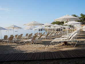 On the beach, sun loungers, beach umbrellas, beach towels