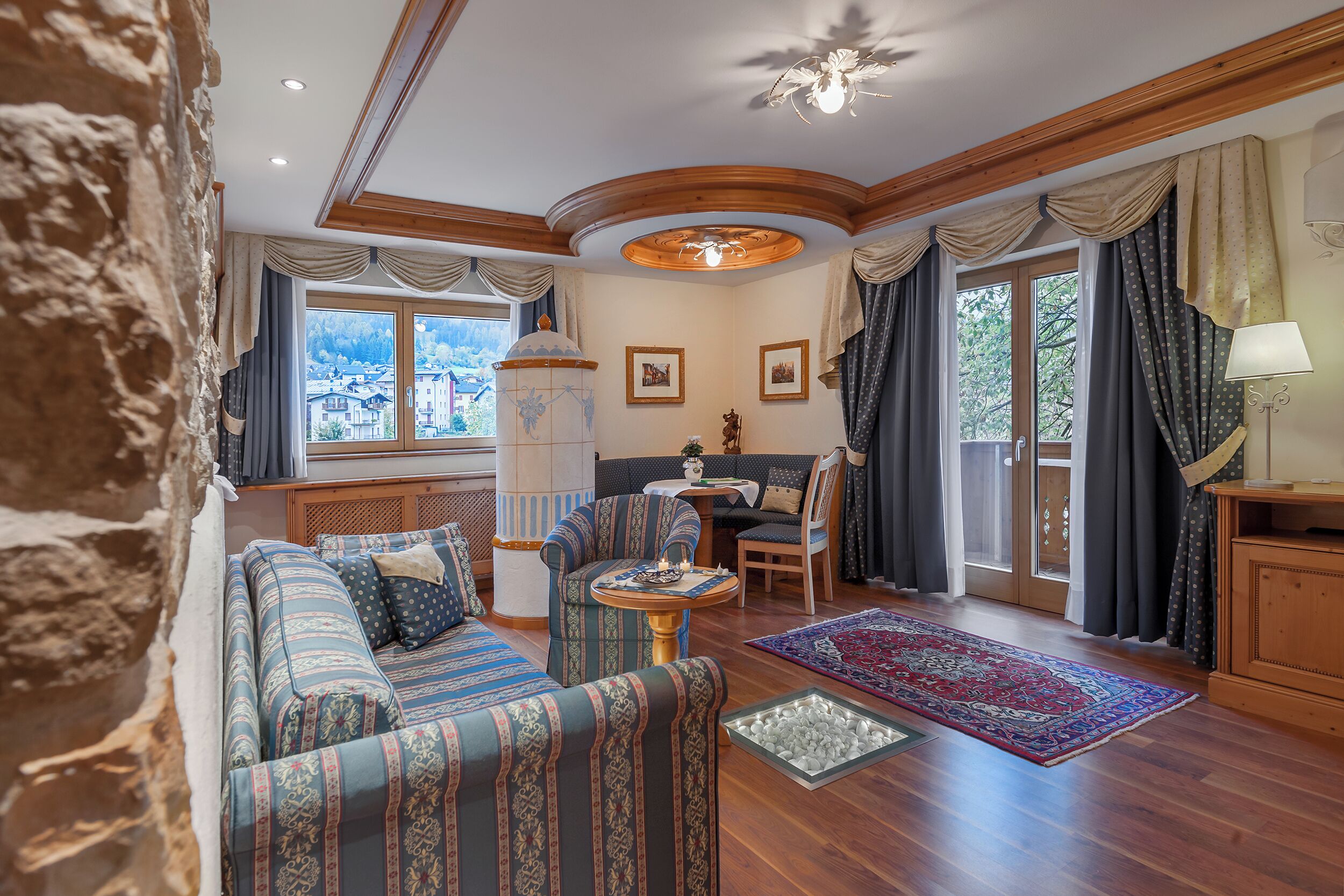 A cozy living room with a sofa set, a small round table, and a patterned rug.