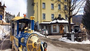 A yellow building with multiple windows and a snow-covered roof. - Vittoria (Folgaria)